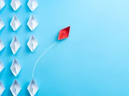White paper ships on a blue background with a single red ship sailing away unique