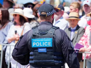 A Canberra police officer standing in front of a crowd