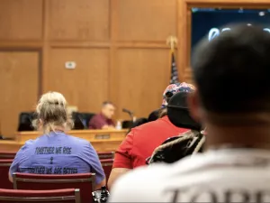 Uvalde teacher Nicole Ogburn sits at a Texas school board meeting in August 2023.