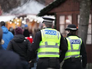 Police in hi-visibility jackets policing crowd control at a UK event