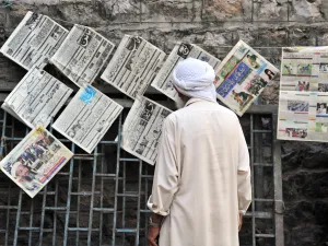 Man reads newspaper in Abbottabad, Pakistan.