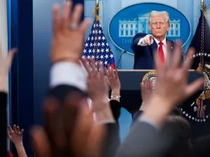 Trump calls on a reporter as other reporters raise their hands