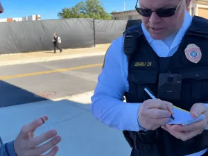 Officer Taking Notes on Campus Street