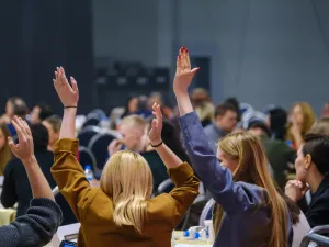 female students raise hands in class