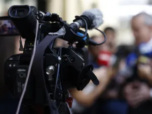 Image of a camera during a press conference
