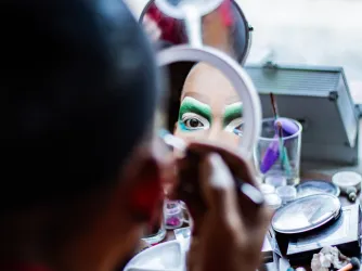 Drag performer putting on makeup