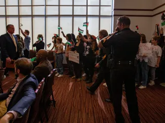Florida State University students attend an FSU Board of Trustees meeting where they waived Palestinian flags and chanted before being escorted out by the police
