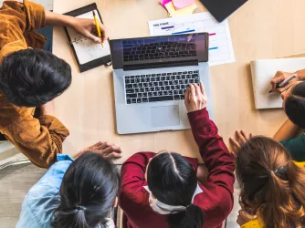 Students working around a table