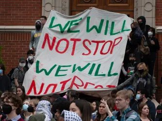 Pro-Palestinian protesters march down East 13th Ave during a rally on the University of Oregon campus in support of a cease fire in Gaza.
