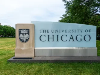 A University of Chicago sign on the Midway Plaisance in summer