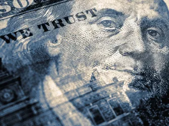 Hundred dollar bill with portrait of Benjamin Franklin in focus Blue tinted illustration