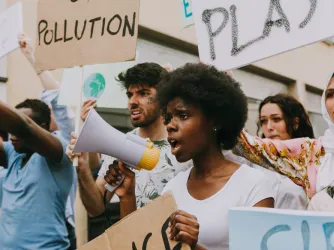 student protesters holding bullhorns and signs