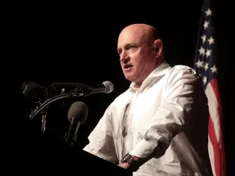 Senator Mark Kelly delivering a speech