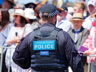 A Canberra police officer standing in front of a crowd
