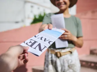 Person hands out flyers