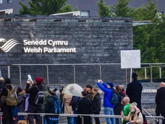 Protesters gather on the steps of the Welsh Parliament in November 2021.