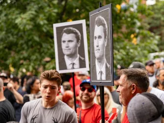 Charlie Kirk posters at an anti-immigration rally in Canada in September 2025.