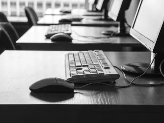 Corporate classroom with keyboards and screens
