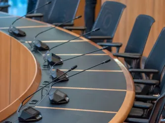 Empty seats for a city council meeting (Image via Shutterstock.com)