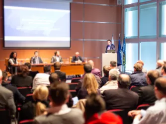 Speaker commenting at a public meeting like city council or school board (Image via Shutterstock.com)