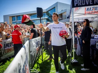 Charlie Kirk tossing hats before his last speech to Utah Valley University. (Image via Shutterstock.com)