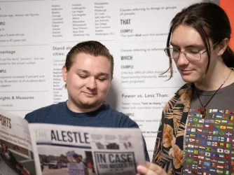SEIU Alestle editors Dylan Hembrough and Gavin Quinlan reading the student newspaper