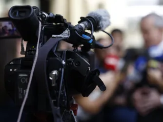 Image of a camera during a press conference