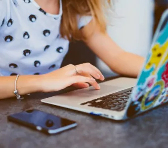 Student using a laptop and mobile phone