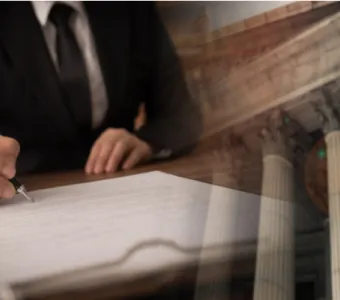 lawyer signing legal document and agreement with court building in background