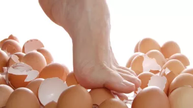 Foot walking on broken eggshells