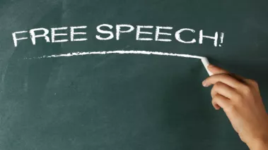Free Speech written in chalk on green chalkboard