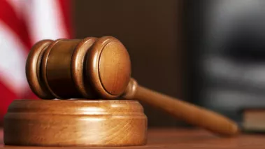 gavel in a courtroom with US flag