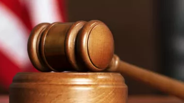 gavel in a courtroom with US flag