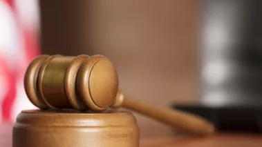 gavel in a courtroom with US flag