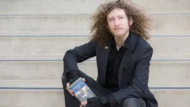 what are my rights on campus? Kevin Shaw holding a pocket edition of the US constitution