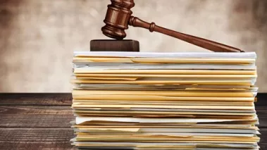 Gavel on a stack of folders.