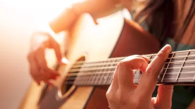 woman playing guitar