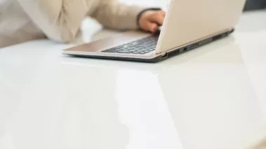 Person sitting at counter filling out online application