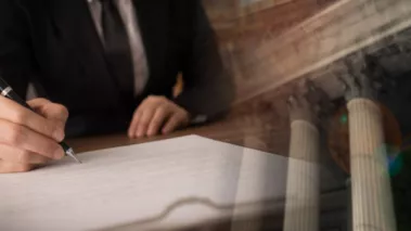 lawyer signing legal document and agreement with court building in background