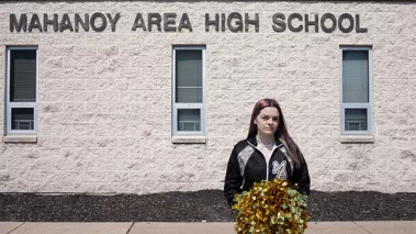 Brandi Levy stands before Mahanoy Area High School