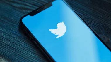 Blue Twitter logo on a smart phone