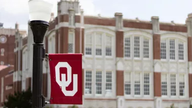 University of Oklahoma banner next to a building on the main campus in Norman
