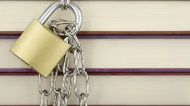padlock with chain against books closeup