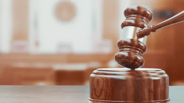 Wooden gavel on table close up.