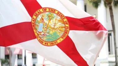 State of Florida flag that has the official seal of the state is planted at the East entrance of Old State Capitol in Tallahassee, Florida.