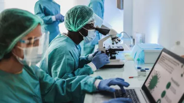 Medical staff wearing PPE conducting research
