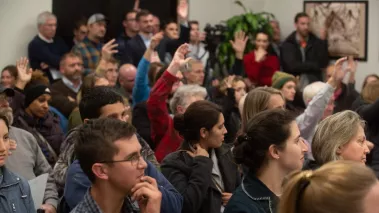 A mix of hands go up from those expressing their opionion to keep the current Pottawatomie-Wabaunsee Regional Library was prompted by resident Dave Perry at Tuesday's St. Mary's City Commission meeting