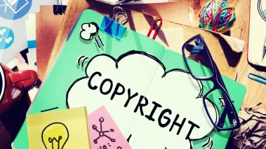 papers on a table with COPYRIGHT written across one page