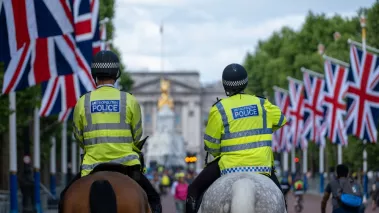  Two Mounted Police Officers Ride down The Mall in London 
