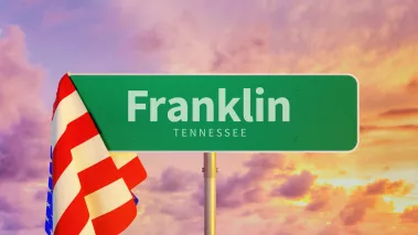 Franklin Tennessee road sign draped with American flag